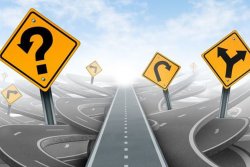 Questions and clear strategy and solutions for business leadership with a straight path to success choosing the right strategic path with yellow traffic signs cutting through a maze of tangled roads and highways. (photo: )